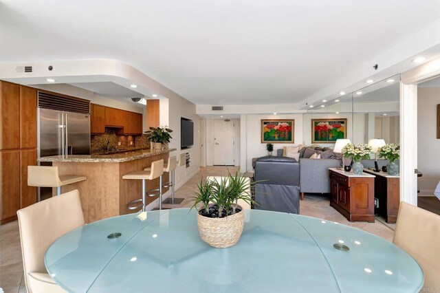dining area featuring light tile patterned flooring, visible vents, and recessed lighting