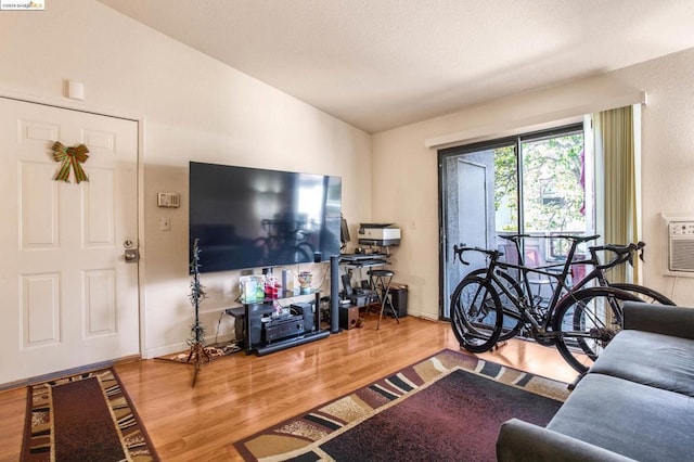 living room with wood-type flooring and vaulted ceiling