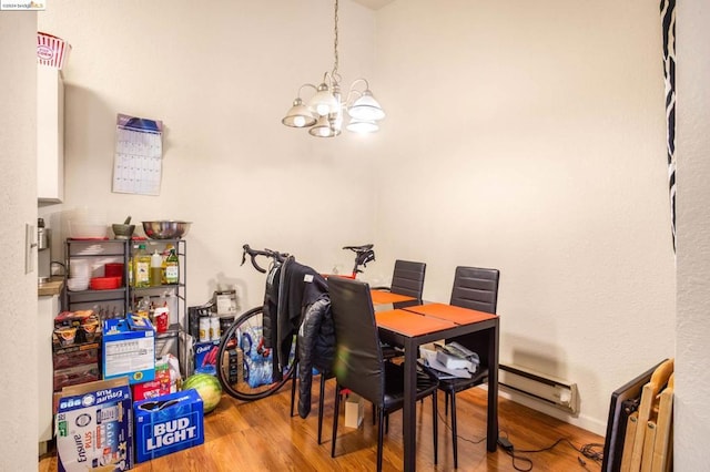 dining room featuring radiator, a notable chandelier, a baseboard radiator, and hardwood / wood-style floors