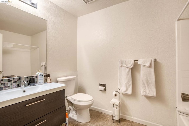 bathroom with toilet, vanity, and walk in shower