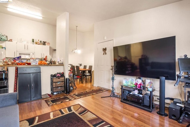 living room featuring light hardwood / wood-style floors and a chandelier