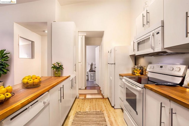 kitchen featuring white cabinetry, light hardwood / wood-style floors, white appliances, and wooden counters