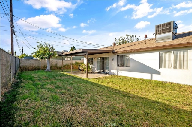 back of house featuring central AC unit, a yard, and a patio