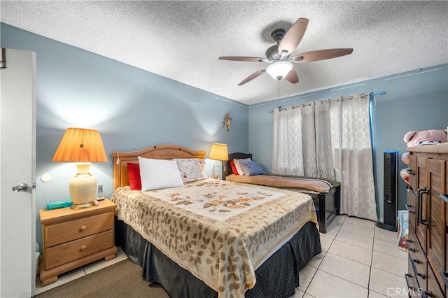 tiled bedroom with ceiling fan and a textured ceiling