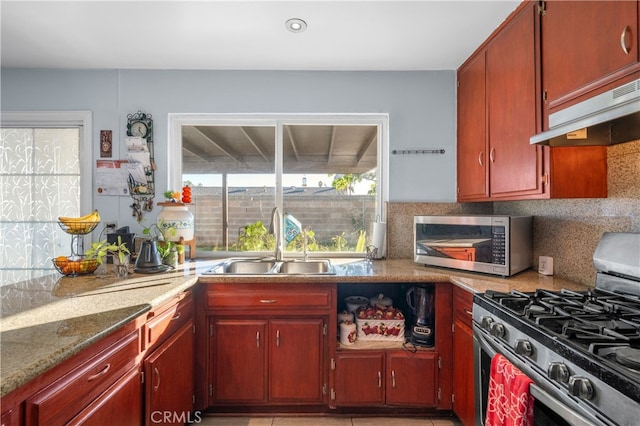 kitchen with sink, stainless steel appliances, and tasteful backsplash