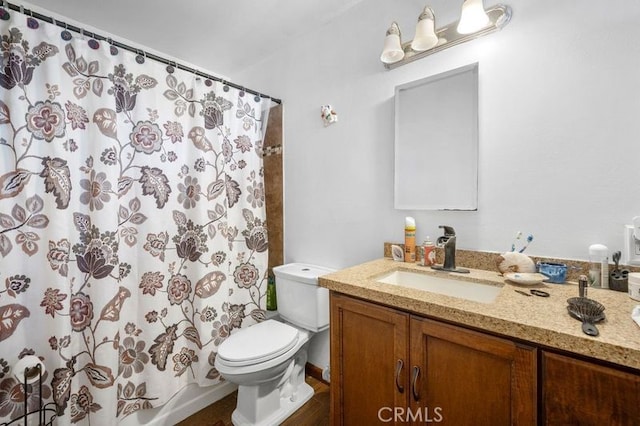 bathroom featuring toilet and vanity