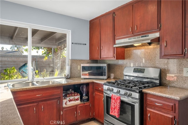 kitchen with sink, appliances with stainless steel finishes, and tasteful backsplash