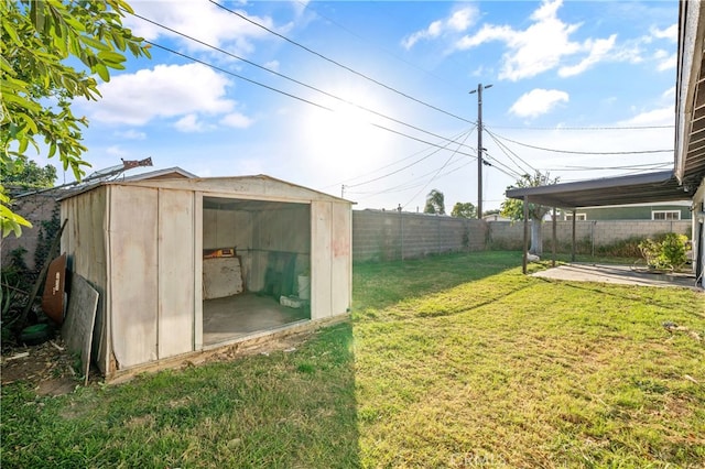 view of yard featuring a patio area and a storage shed