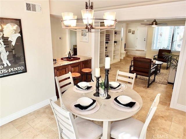 dining room with ceiling fan with notable chandelier