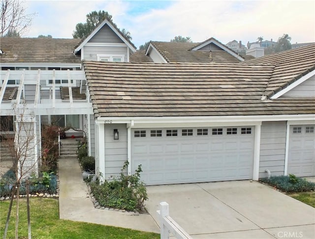 view of front of property featuring a balcony and a garage