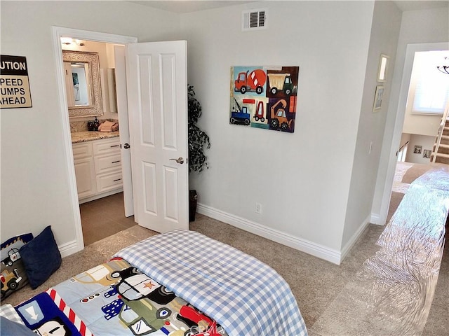 carpeted bedroom with ensuite bath