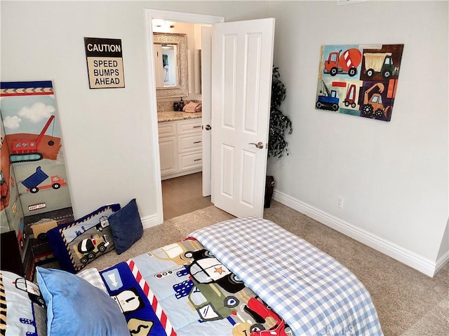 bedroom with light colored carpet and ensuite bath