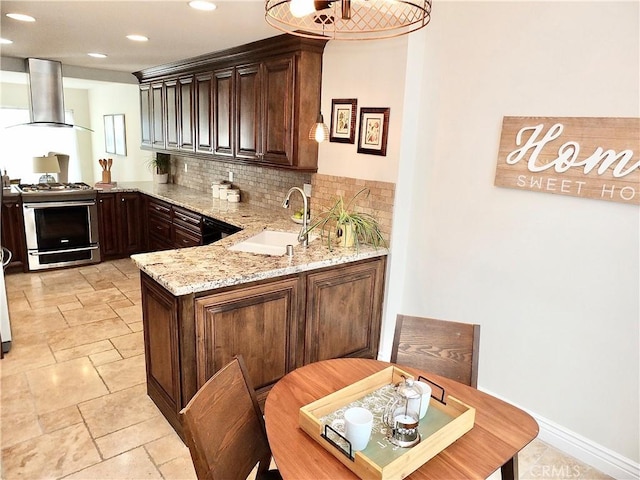 bar featuring gas range gas stove, sink, dark brown cabinetry, wall chimney exhaust hood, and light stone counters