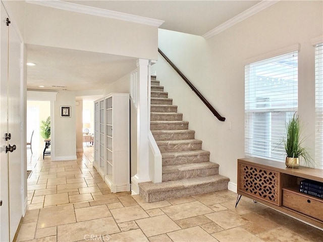 stairway with crown molding and decorative columns