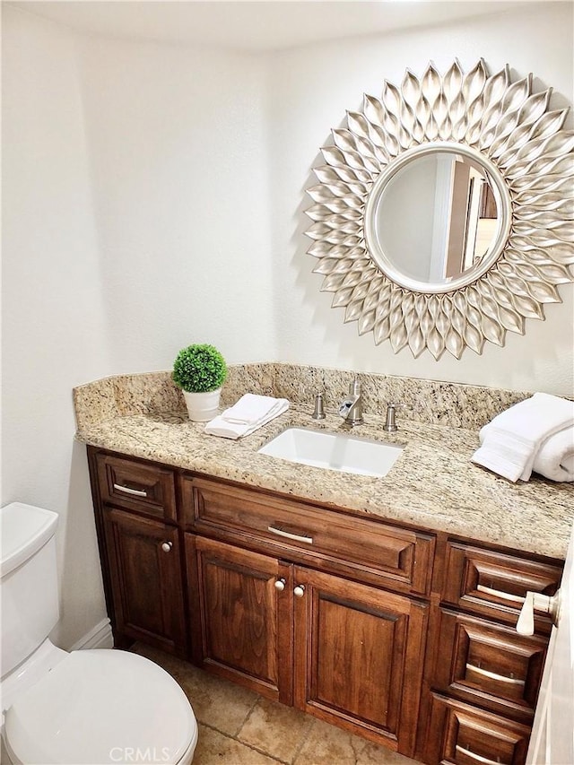 bathroom featuring toilet and vanity