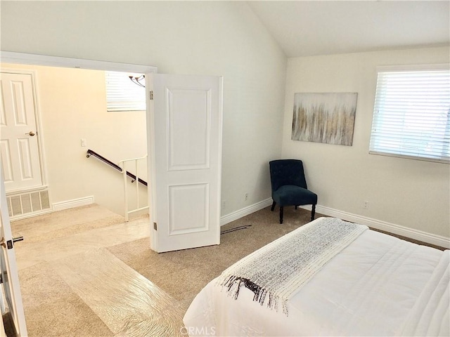 bedroom with light carpet and vaulted ceiling