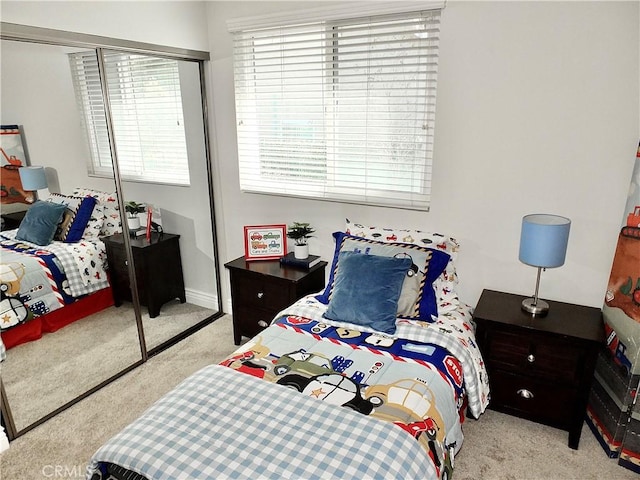 carpeted bedroom featuring a closet