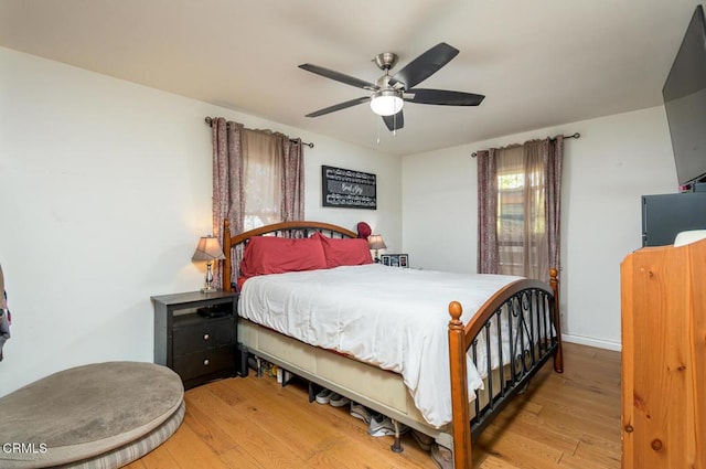 bedroom with ceiling fan and light hardwood / wood-style flooring