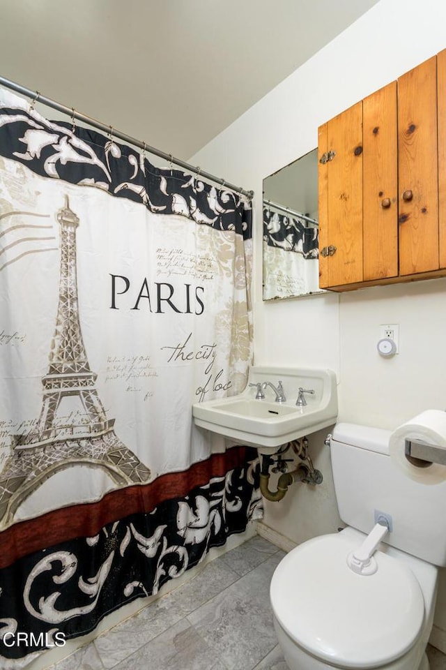 bathroom featuring toilet and sink