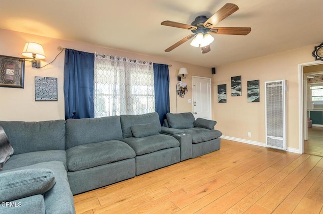 living room with ceiling fan, a wealth of natural light, and hardwood / wood-style flooring