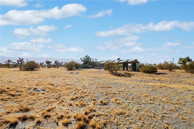 view of yard with a mountain view and a rural view