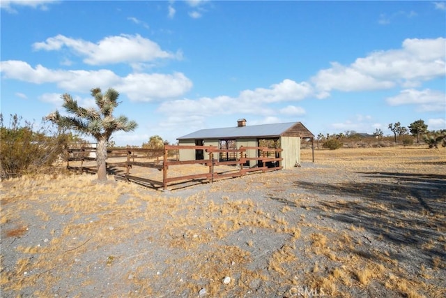 exterior space with a rural view and an outdoor structure