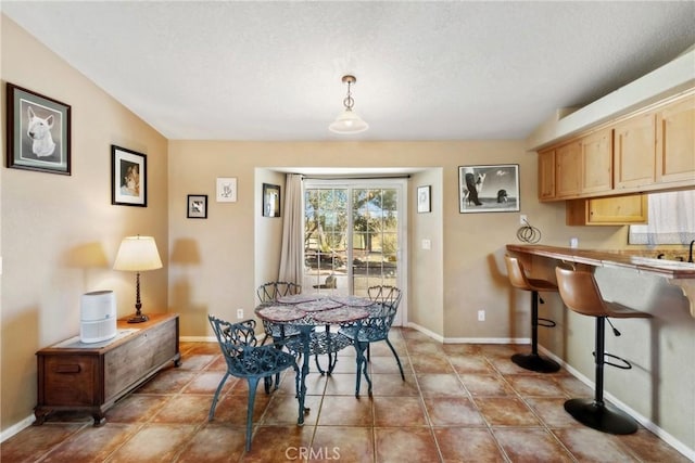 dining space featuring light tile patterned floors