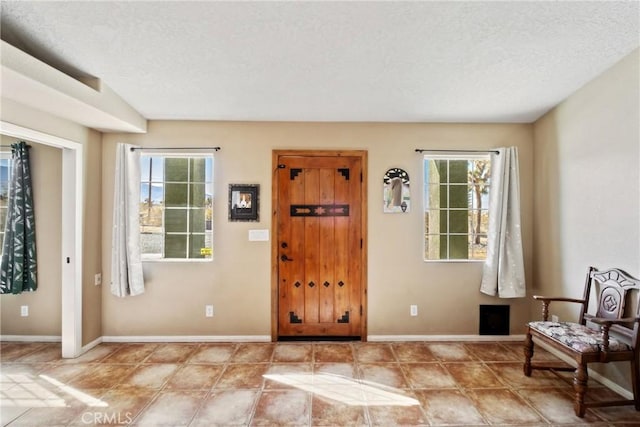 entryway with plenty of natural light and a textured ceiling