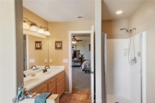 bathroom with vanity, ceiling fan, tile patterned floors, and a shower with door