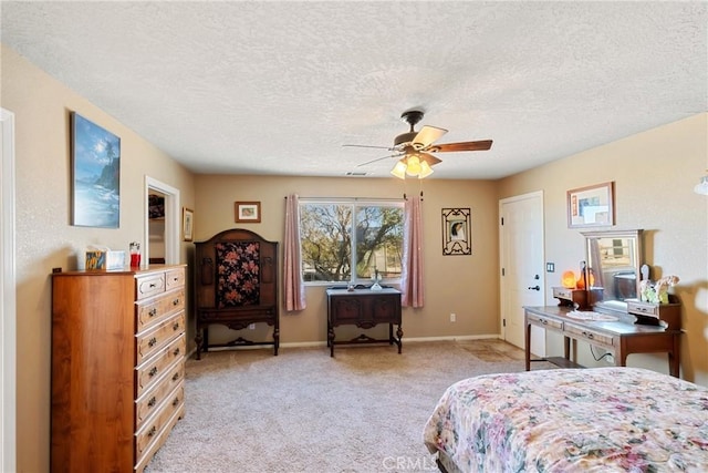 carpeted bedroom with ceiling fan and a textured ceiling