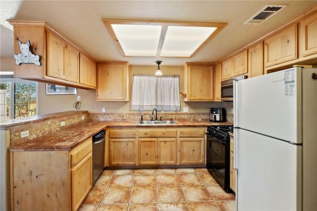 kitchen featuring pendant lighting, stainless steel appliances, light brown cabinetry, sink, and kitchen peninsula