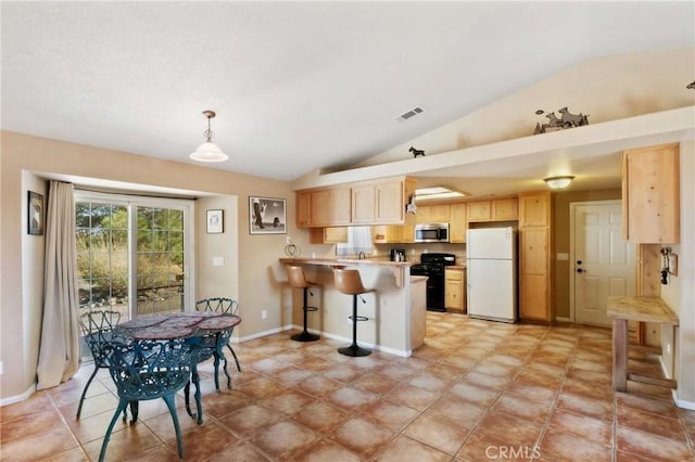 kitchen with black range oven, white refrigerator, light brown cabinetry, hanging light fixtures, and kitchen peninsula