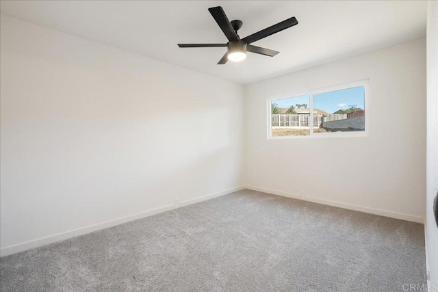 carpeted empty room featuring ceiling fan