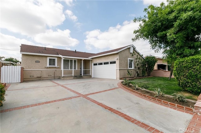 ranch-style home featuring a garage and a front lawn