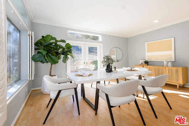 dining area with french doors, a wealth of natural light, ornamental molding, and light hardwood / wood-style floors