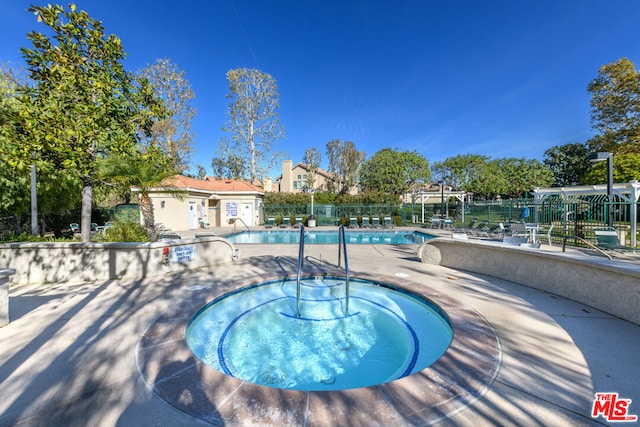 view of pool featuring a patio area and a hot tub