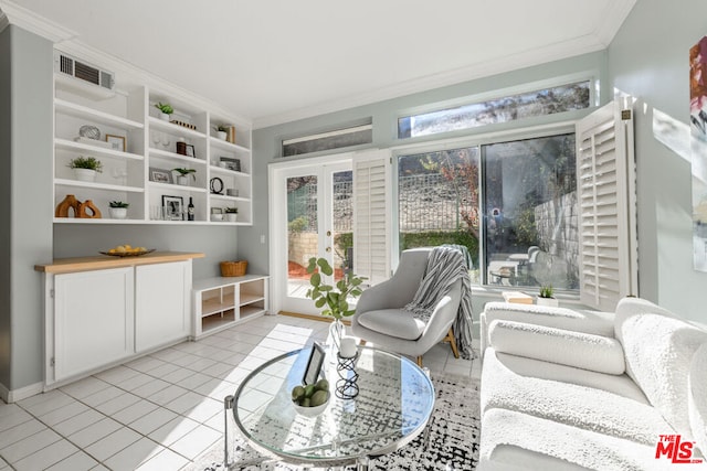 sitting room with light tile patterned floors, french doors, and crown molding