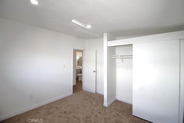 unfurnished bedroom with a closet and carpet flooring