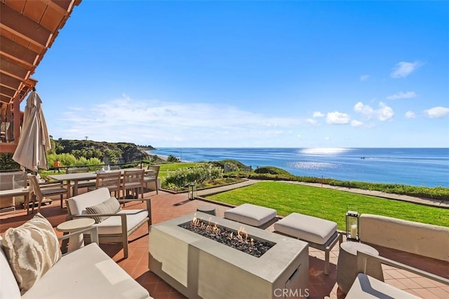 view of patio / terrace with a water view and an outdoor fire pit