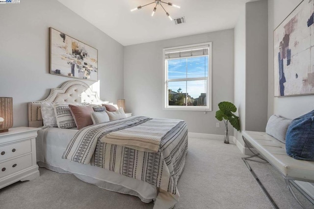 carpeted bedroom with an inviting chandelier