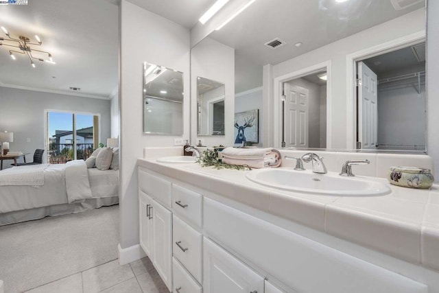 bathroom featuring vanity, tile patterned floors, and crown molding