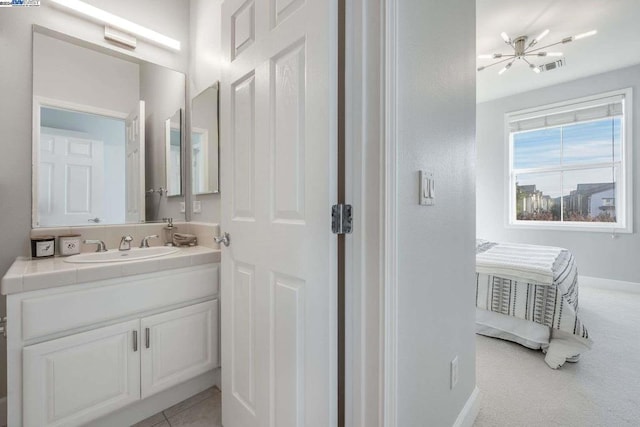 bathroom featuring vanity and a notable chandelier