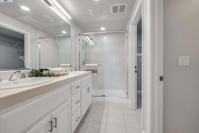 bathroom with vanity, tile patterned floors, and walk in shower