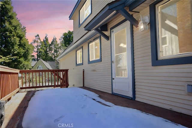 property exterior at dusk with a wooden deck