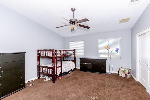 bedroom featuring ceiling fan, dark carpet, and a closet