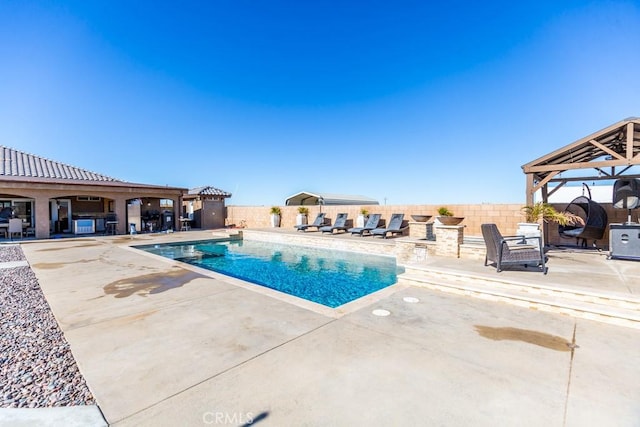 view of swimming pool featuring a patio area