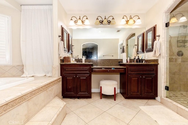 bathroom with walk in shower, vanity, and tile patterned flooring