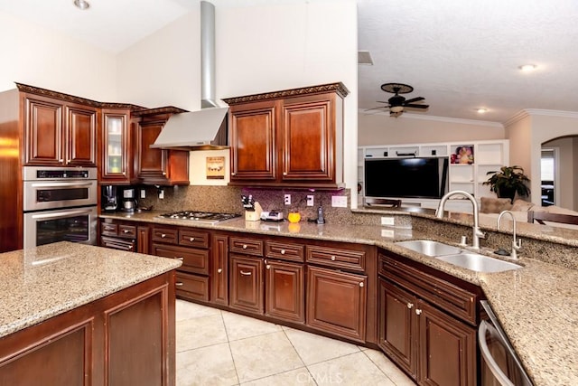 kitchen with stainless steel appliances, tasteful backsplash, vaulted ceiling, wall chimney exhaust hood, and sink