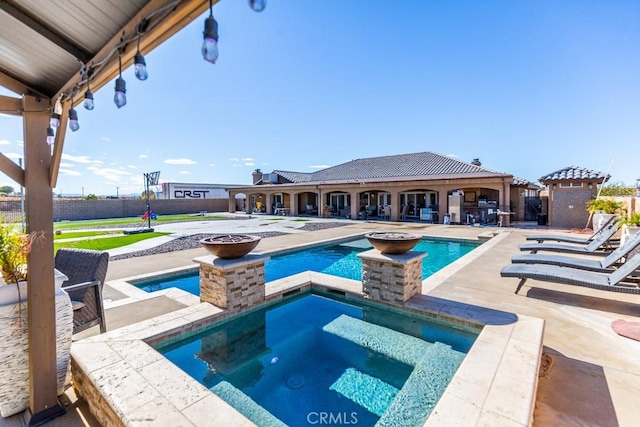 view of pool with a patio and an in ground hot tub