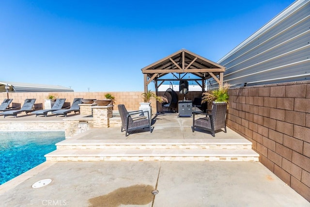 view of patio / terrace featuring a gazebo and a fenced in pool